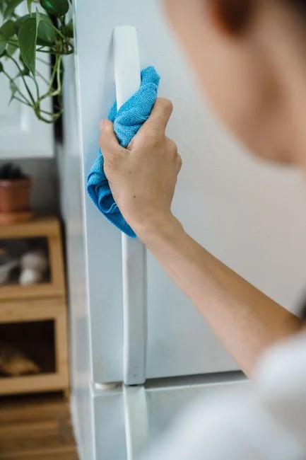 services-02 A person disinfecting a bathroom sink with a spray bottle to maintain cleanliness and hygiene