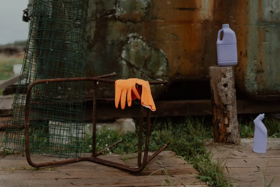 Close-up view of a person cleaning a bathroom sink with gloves and a cloth, with an emphasis on hygiene and cleanliness.